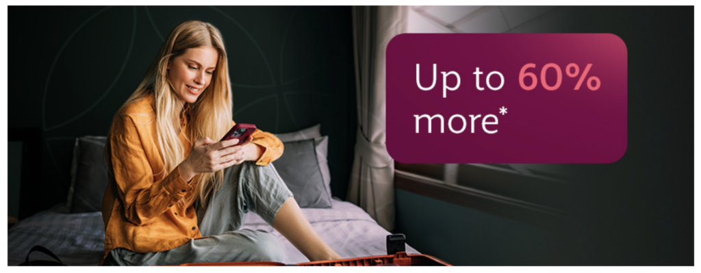 a woman sitting on a bed holding a phone